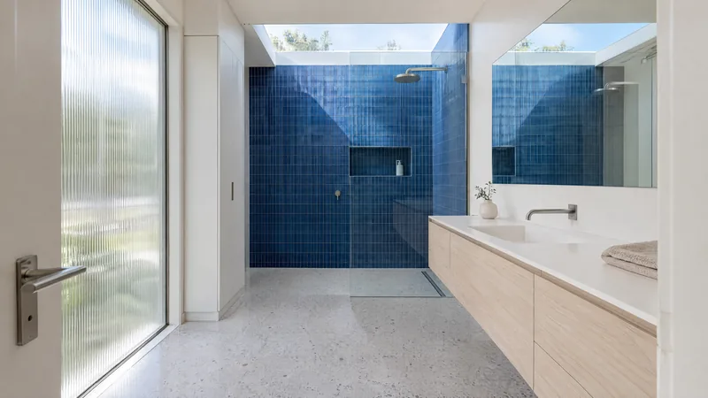 cobalt accent bathroom design concept: White terrazzo, cobalt tile, pale ash and bright daylight